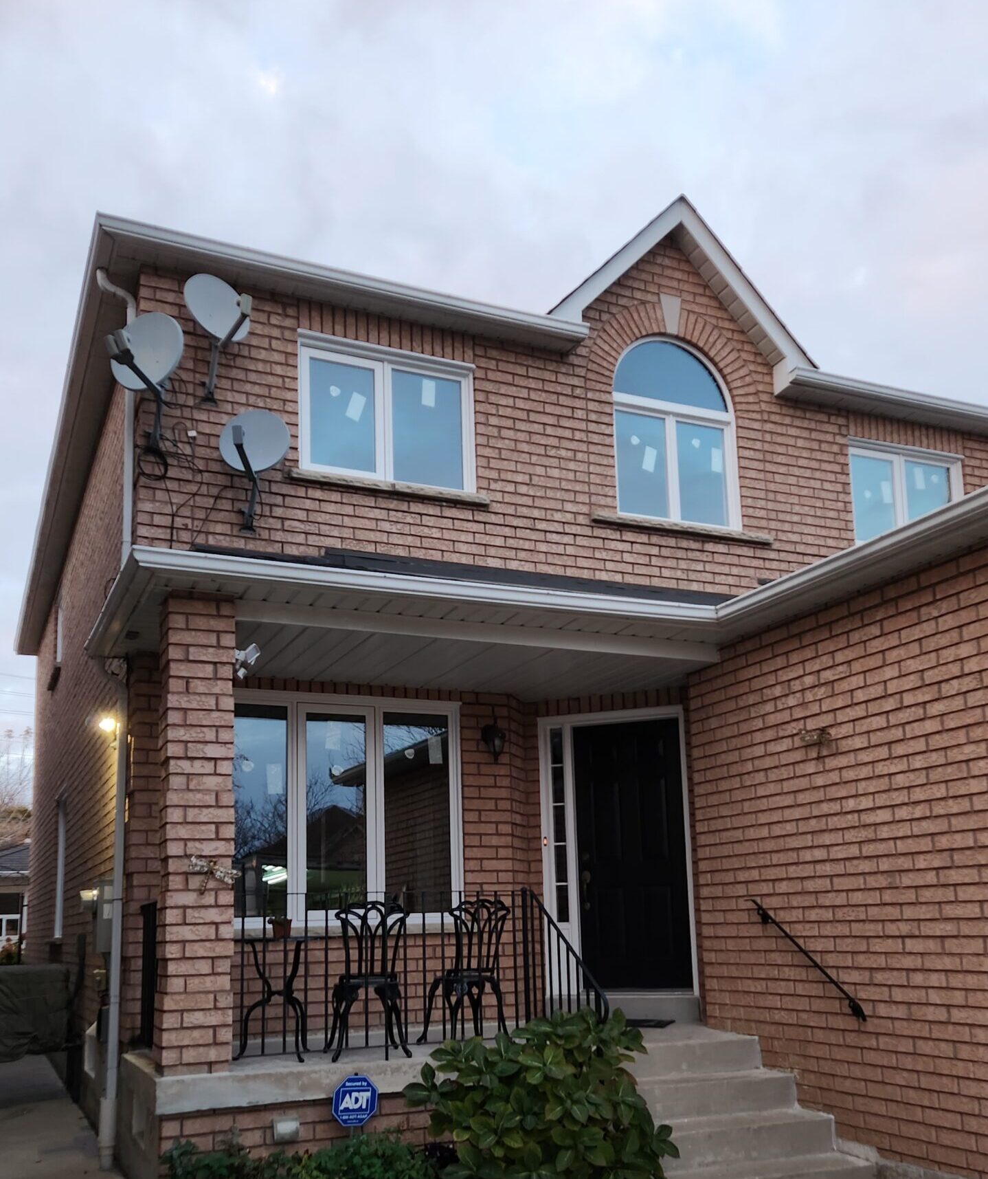Barrie home with replacement windows and a black entry door