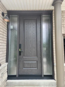 Woodgrain-textured fiberglass entry door with two full-height textured-glass sidelights in Guelph.