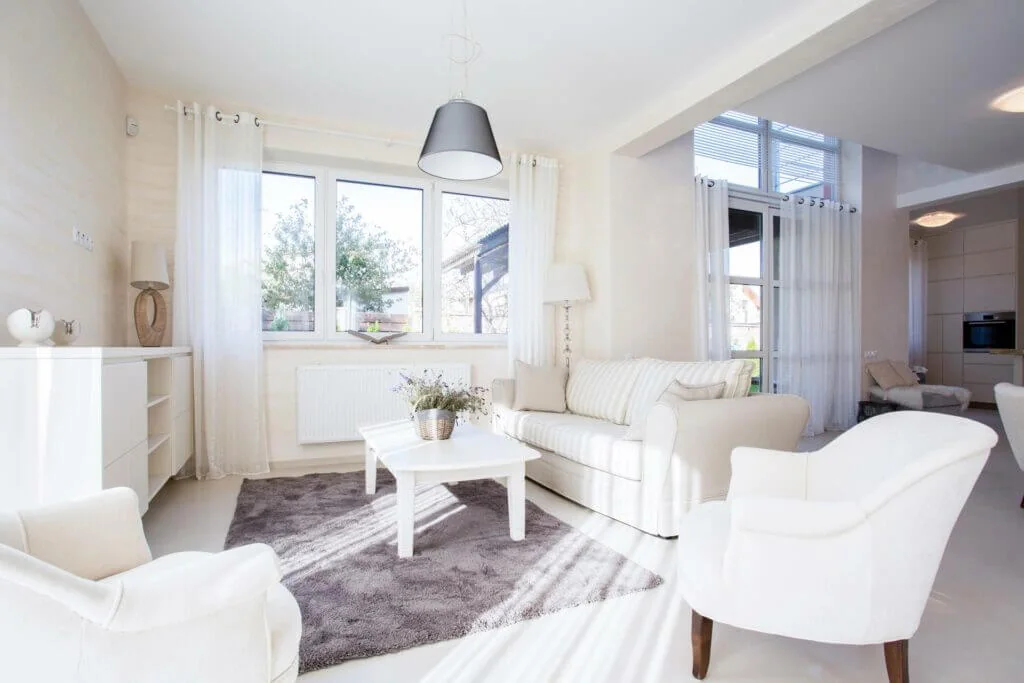 Bright living room with white-framed replacement windows