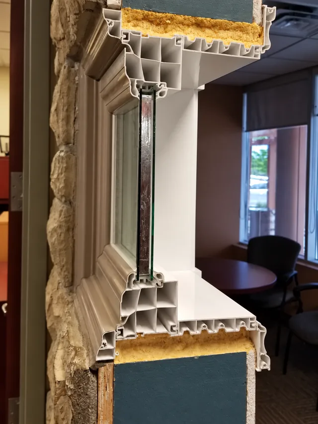 Demonstration cutaway of a full-frame replacement window installation